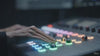 Professional colorist adjusting a DaVinci Resolve control panel, demonstrating the foundational color science and cinematic grading workflow for VELL SUPPLY.